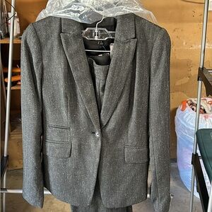 Women’s size 0 suit, gray tweed like material, new with tags, never worn.
